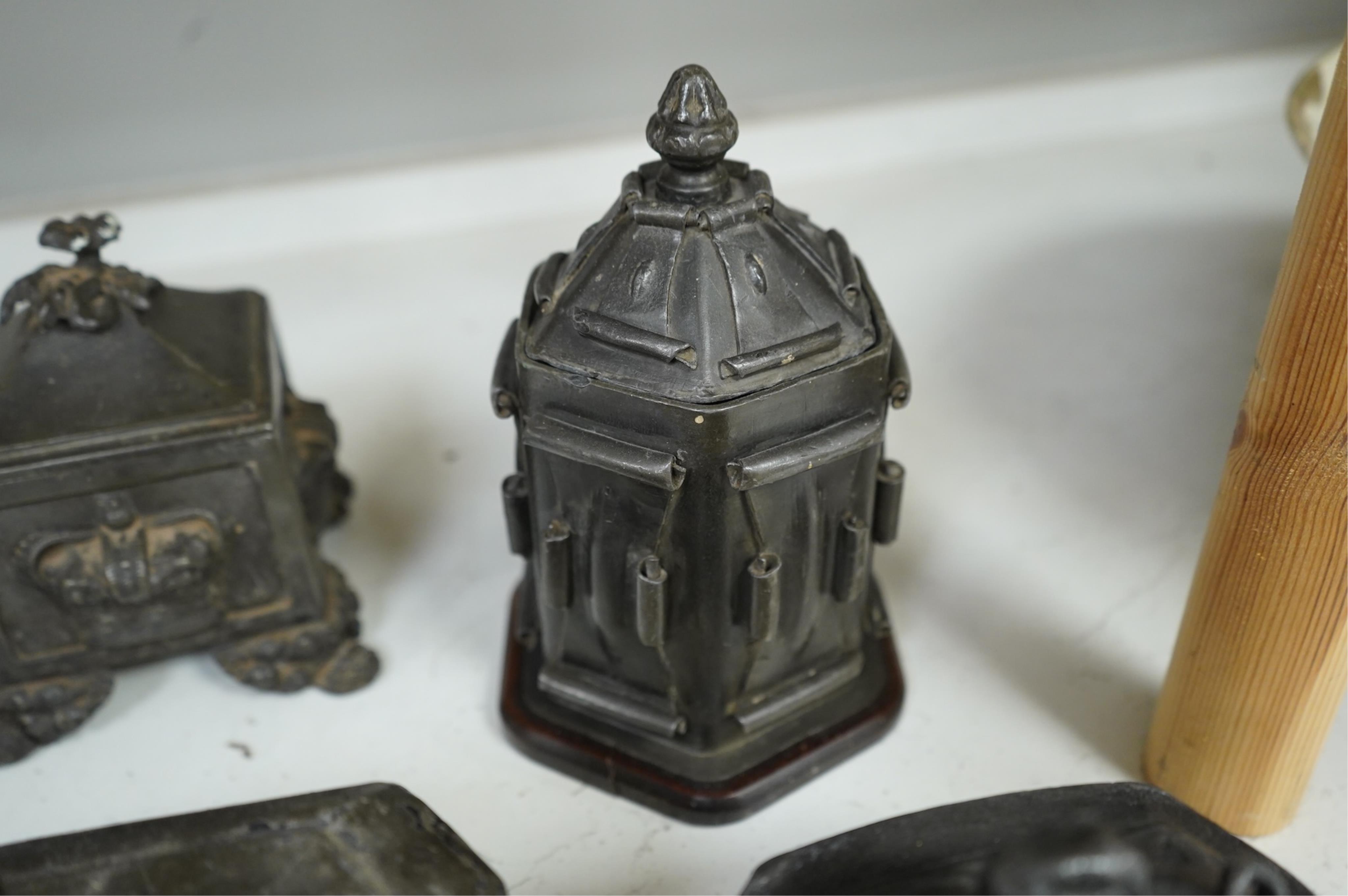 A collection of ten early 19th century lead tobacco boxes to include an octagonal example with remains of paintwork, largest 19cm high
